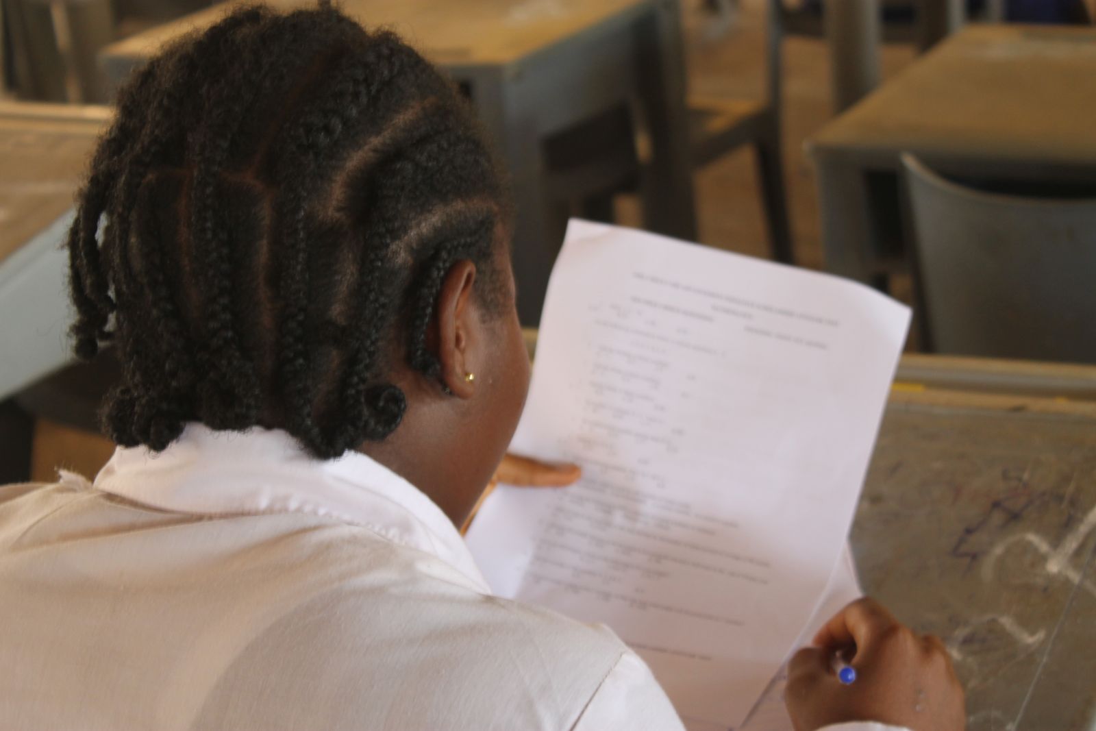 A student works through a paper during a school visit